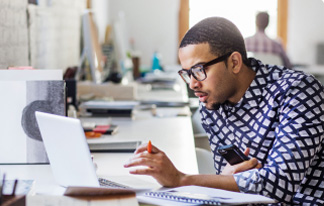 A man working on Networking in laptop